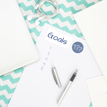 Picture of a notebook with the word 'Goals' written on it.